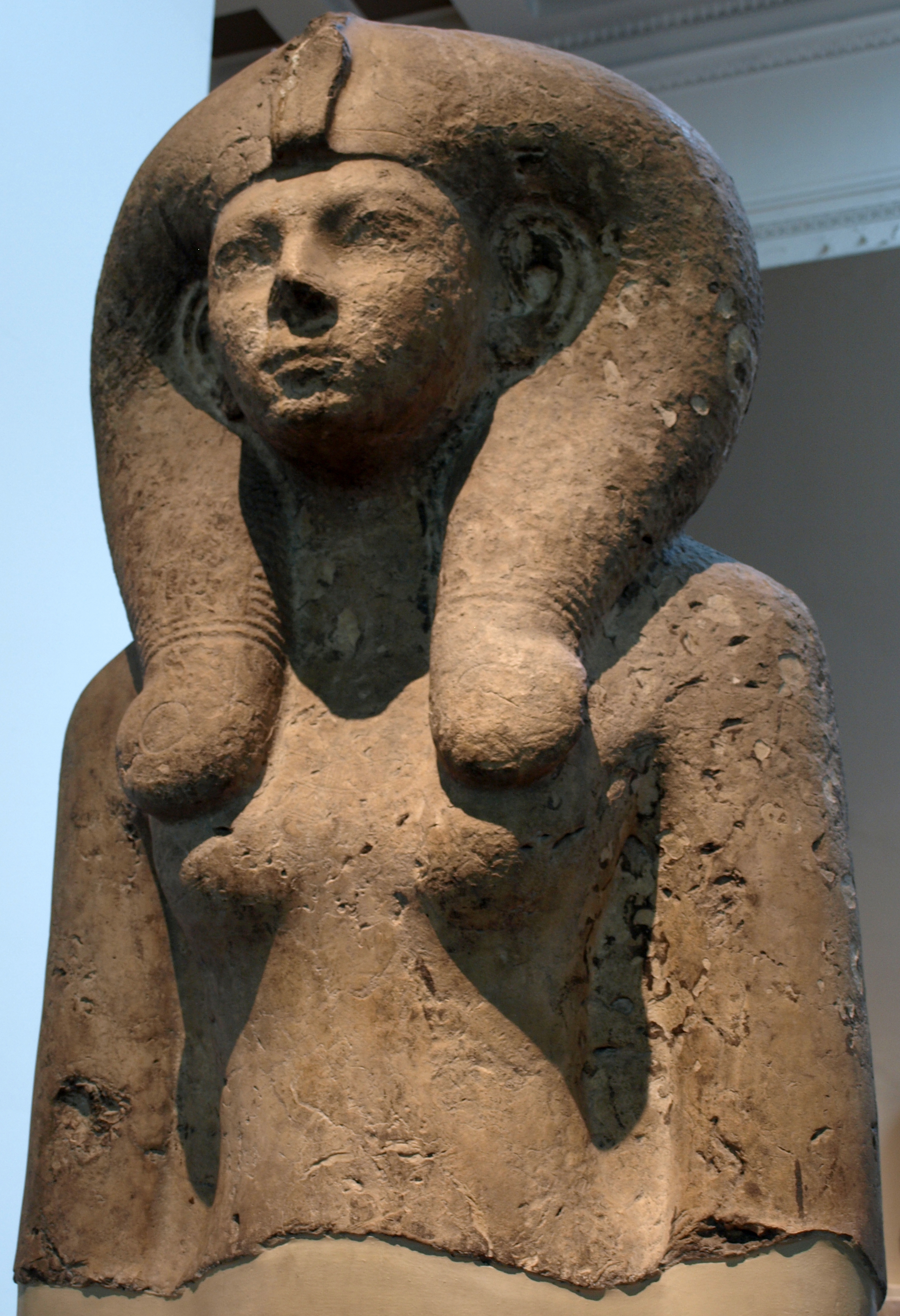 Queen Ah-mose Meritamon in Hãt-HōrꞋ wig ≈BCE1550 lt-brwn limestone 3½ m (BritMus Pylon8 Karnak)